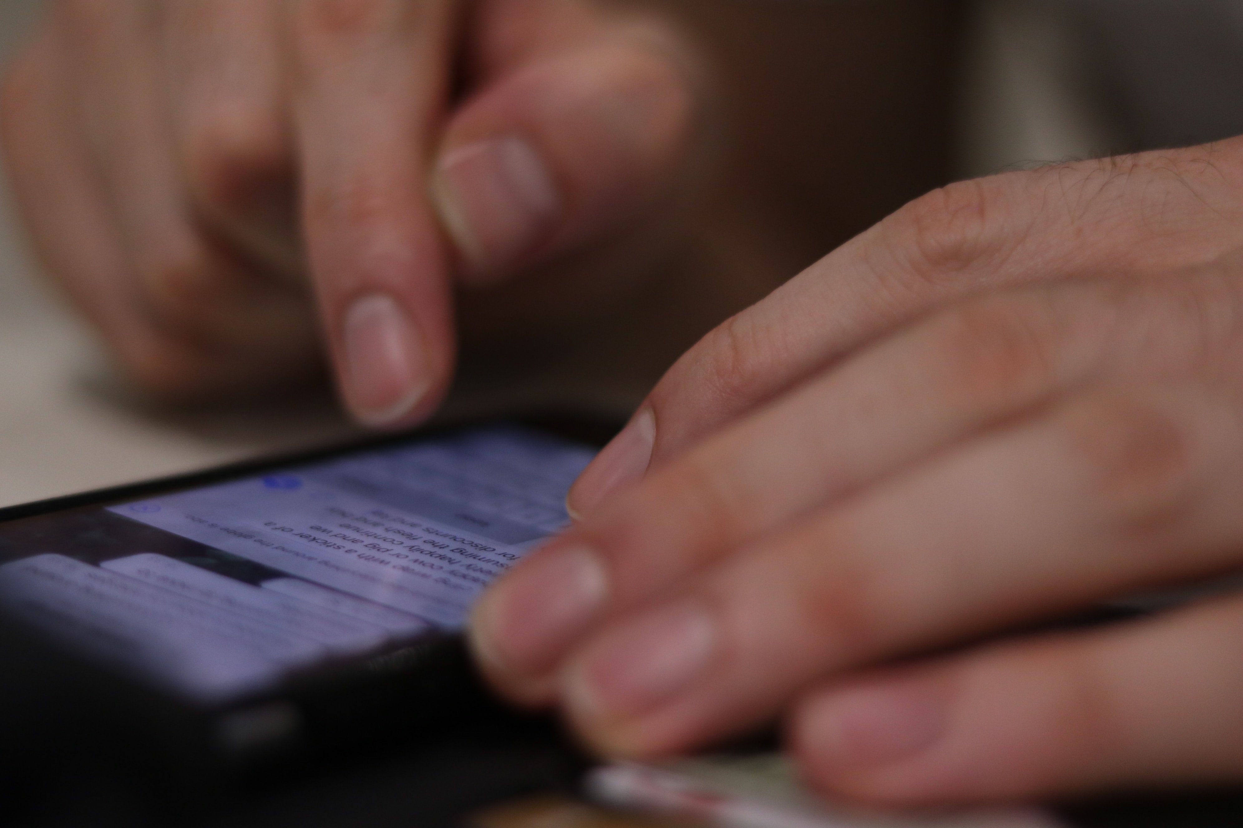 hand texting on phone