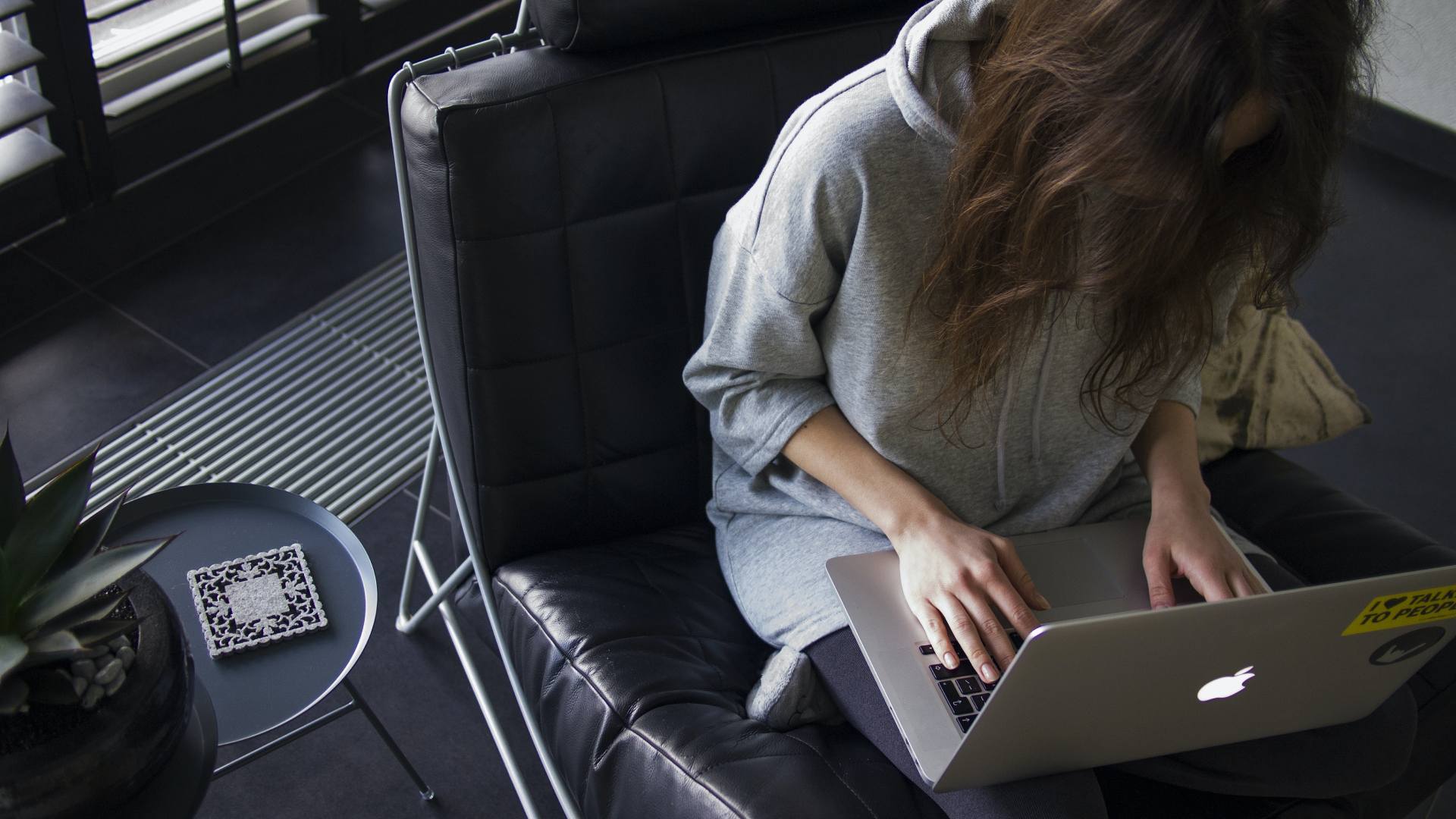 aerial shot of women typing on laptop
