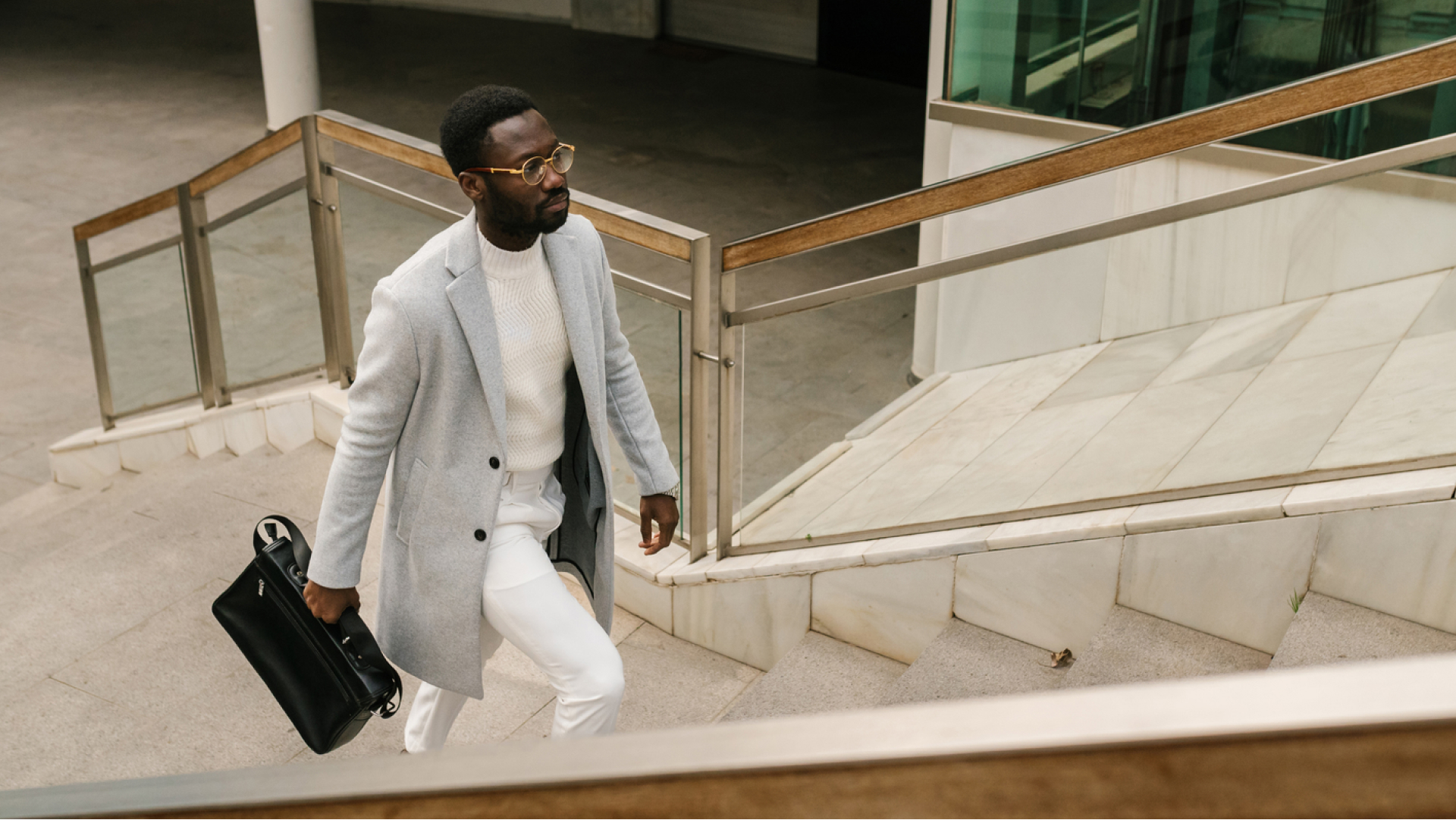 professional real estate agent walking up stairs with briefcase