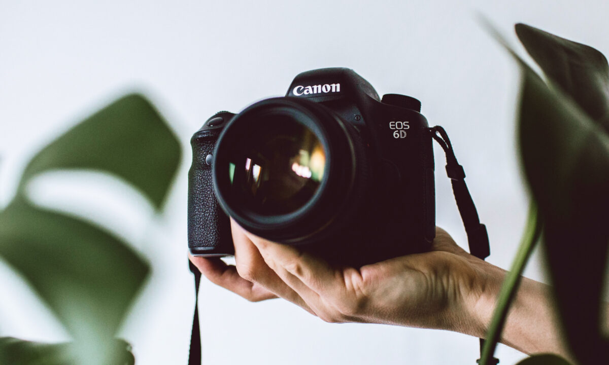 image of photographer holding camera for a blog article about real estate photography pricing