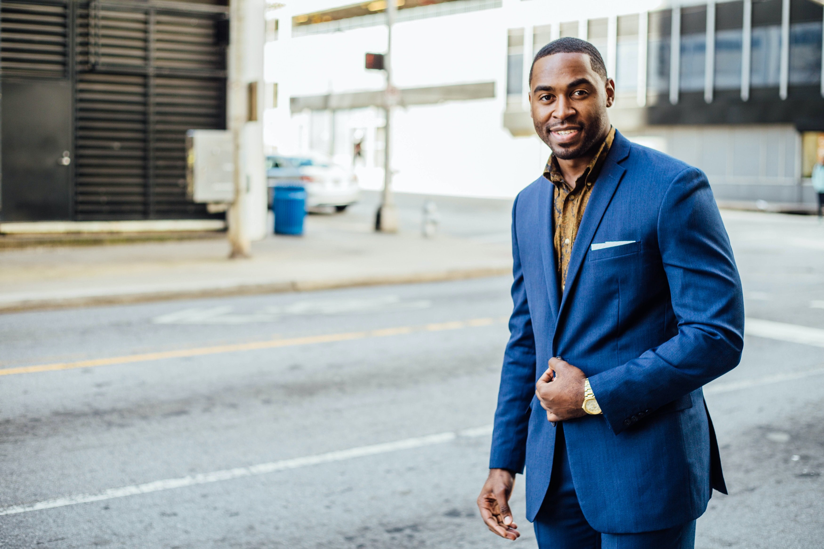 Black business professional wearing suit in city setting
