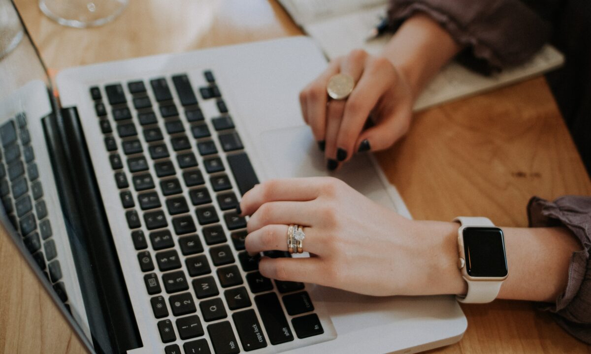 real estate agent typing on laptop for blog about real estate content writing