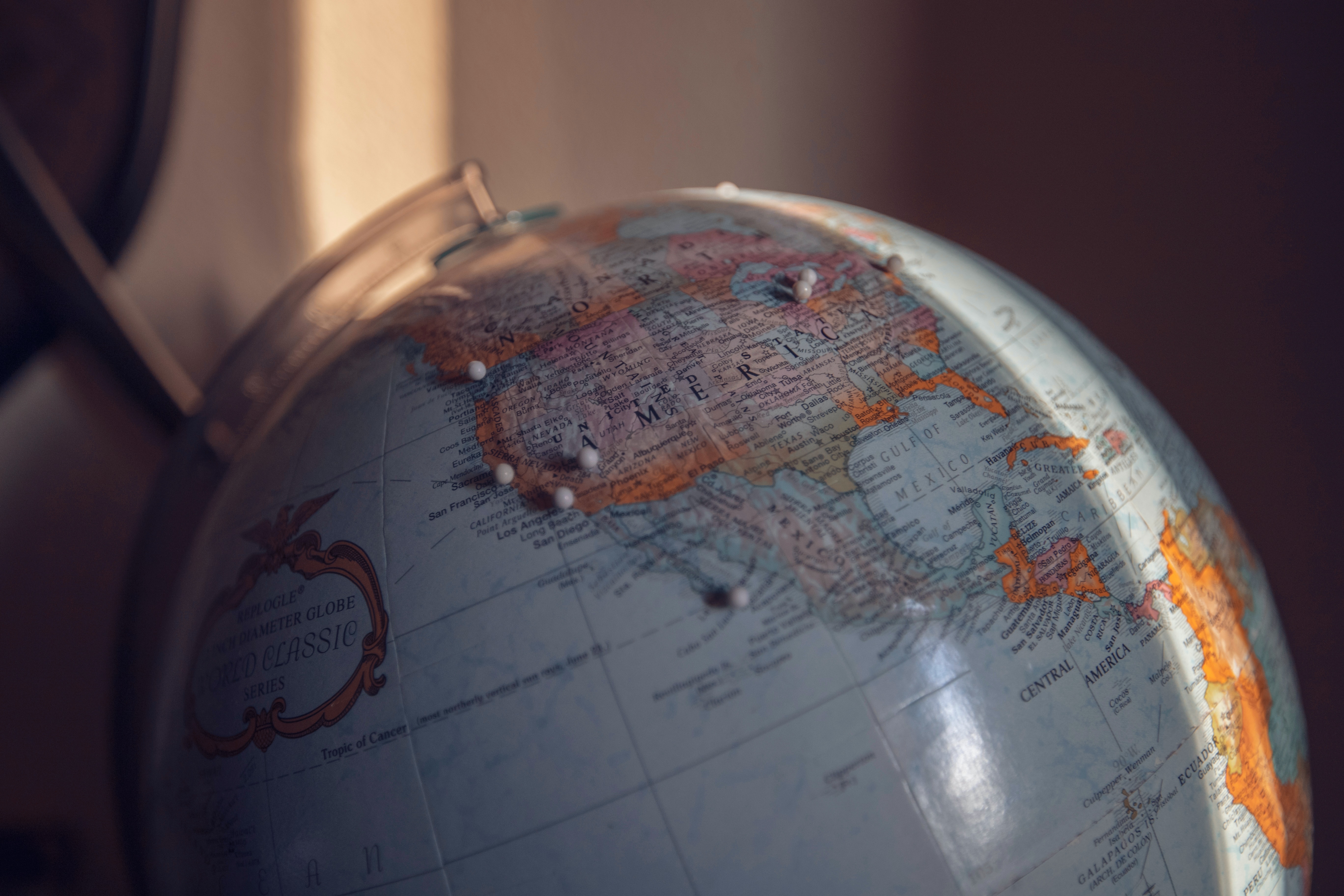 globe with pins in the United States