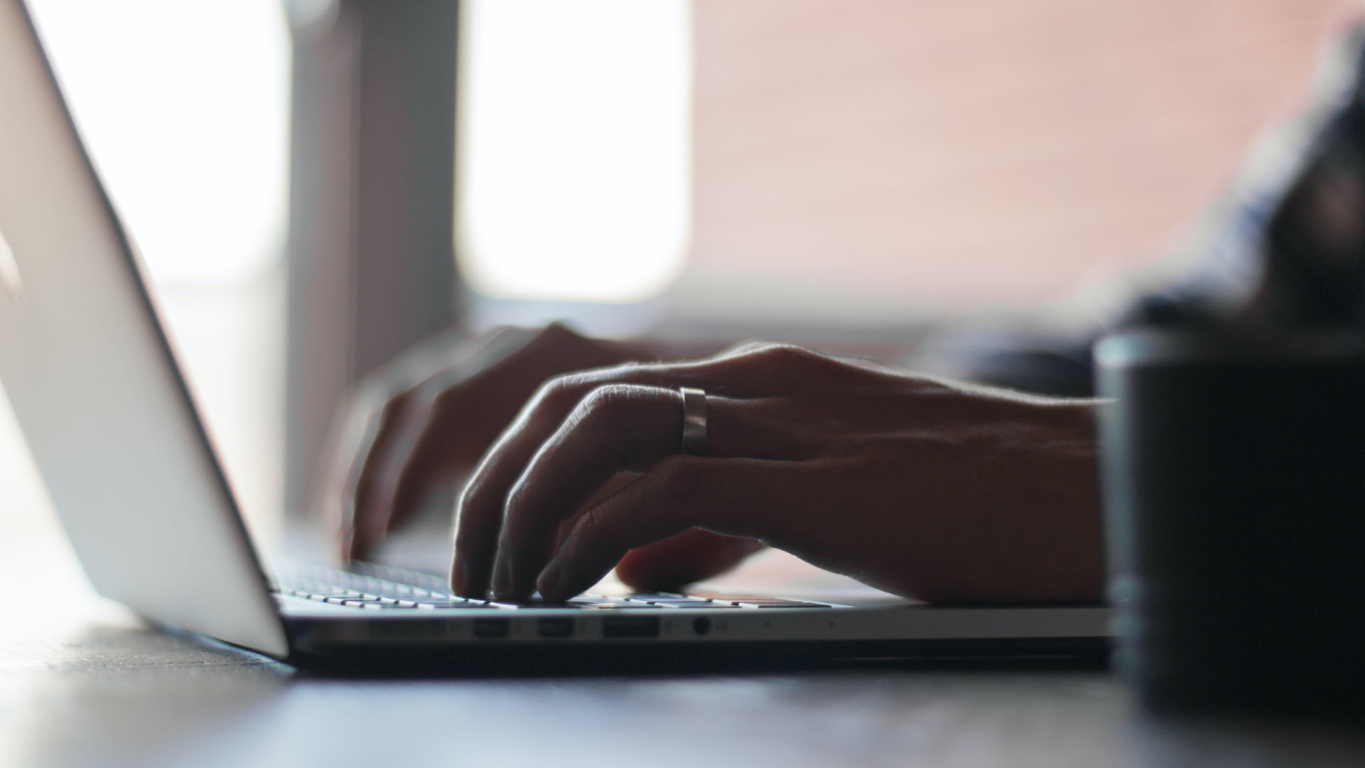 hands typing on laptop 