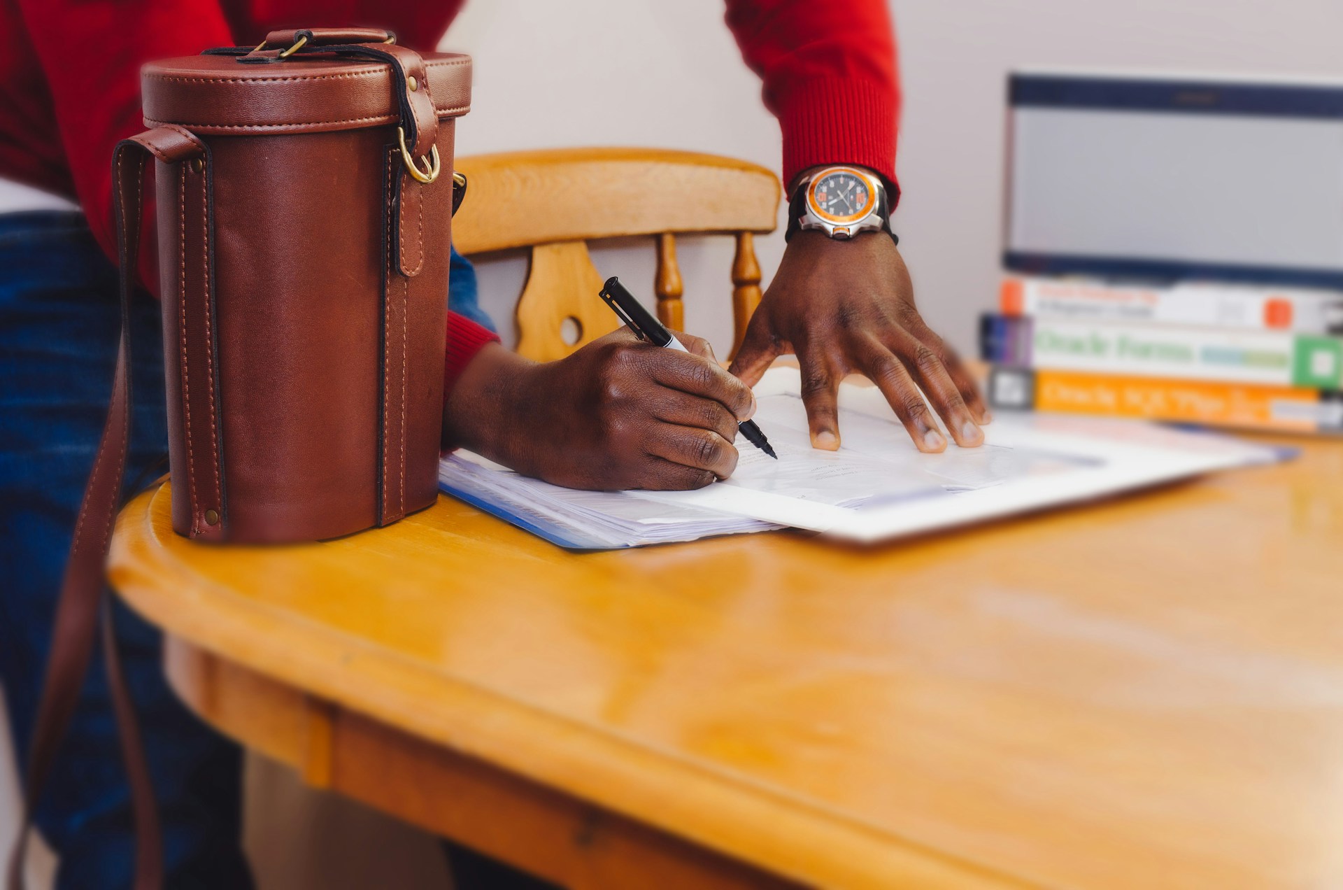 Man signing a real estate referral contract.