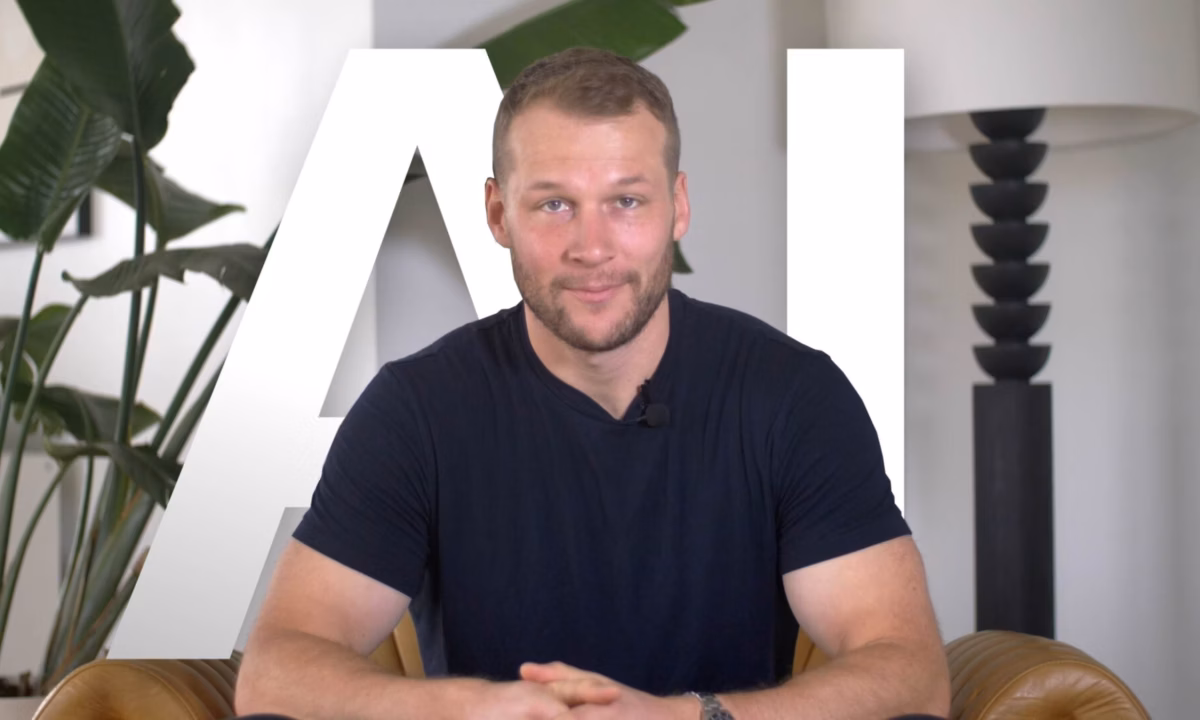 Luxury Presence founder and CEO Malte Kramer sits at a desk in front of the letters "AI" superimposed on the background