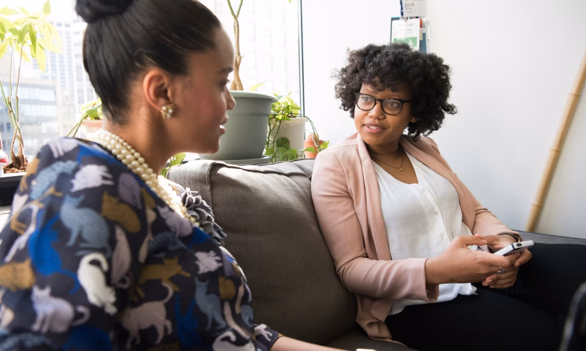 Two women meeting at an event designed to boost an agent's sphere of influence or SOI real estate