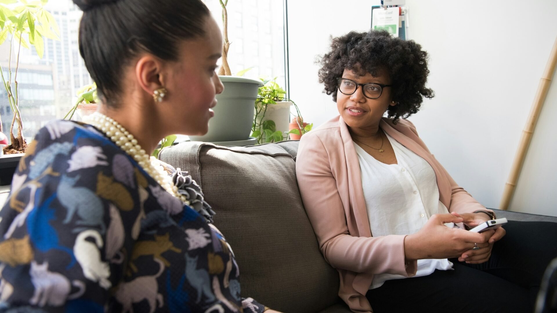 Two women meeting at an event designed to boost an agent's sphere of influence or SOI real estate