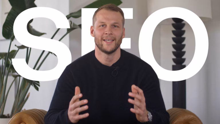 Luxury Presence CEO Malte Kramer stands in front of the words SEO in a still from an educational video on search engine optimization