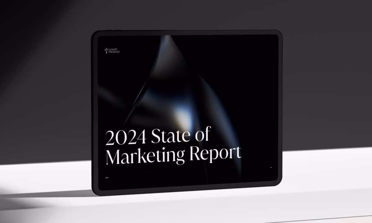 Tablet displaying the 2024 State of Real Estate Marketing report on a white table with a gray background