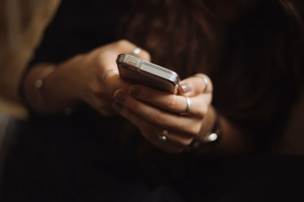 A person texts with a chatbot on their smartphone, illustrating AI lead nurturing in practice