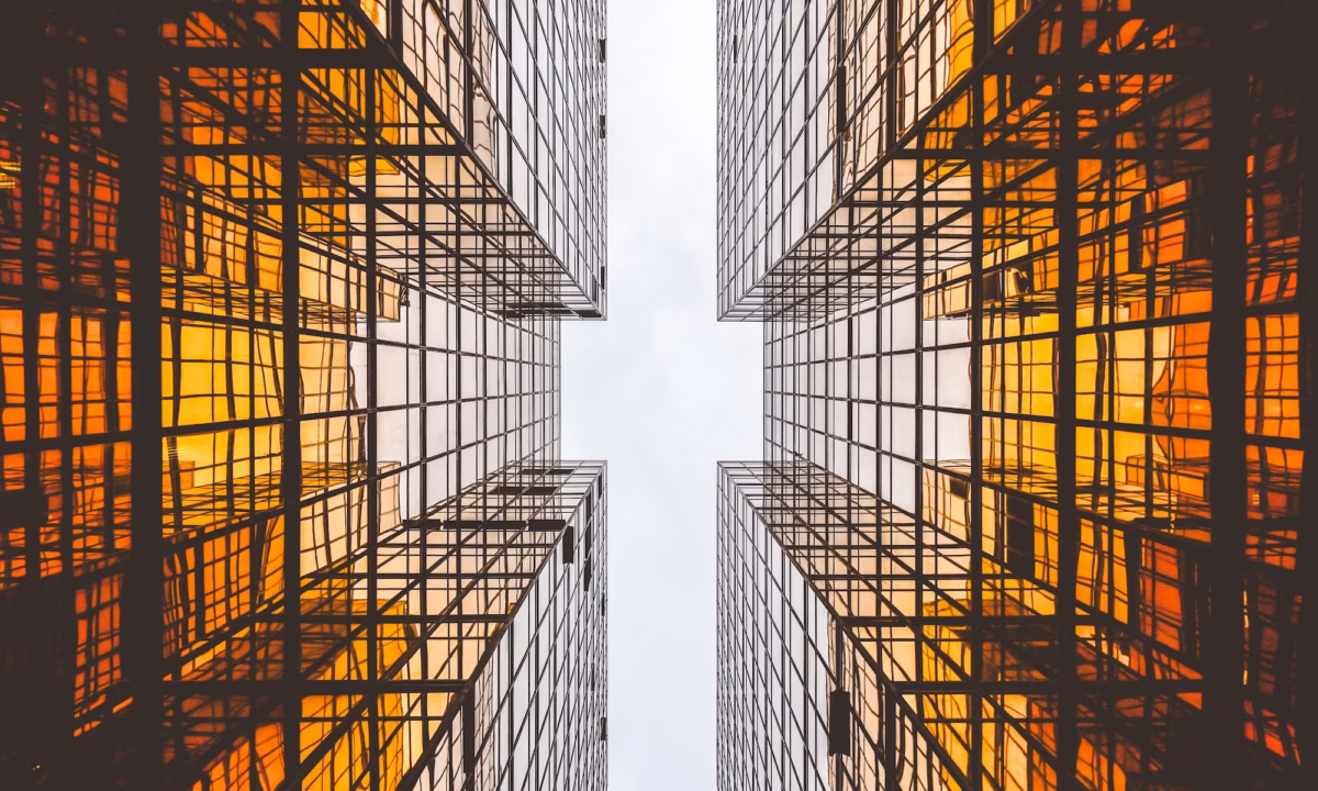 Two amber buildings tower overhead on opposite sides, representing the two sides of the Clear Cooperation Policy