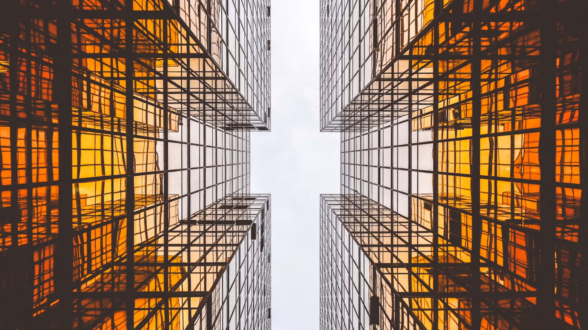 Two amber buildings tower overhead on opposite sides, representing the two sides of the Clear Cooperation Policy