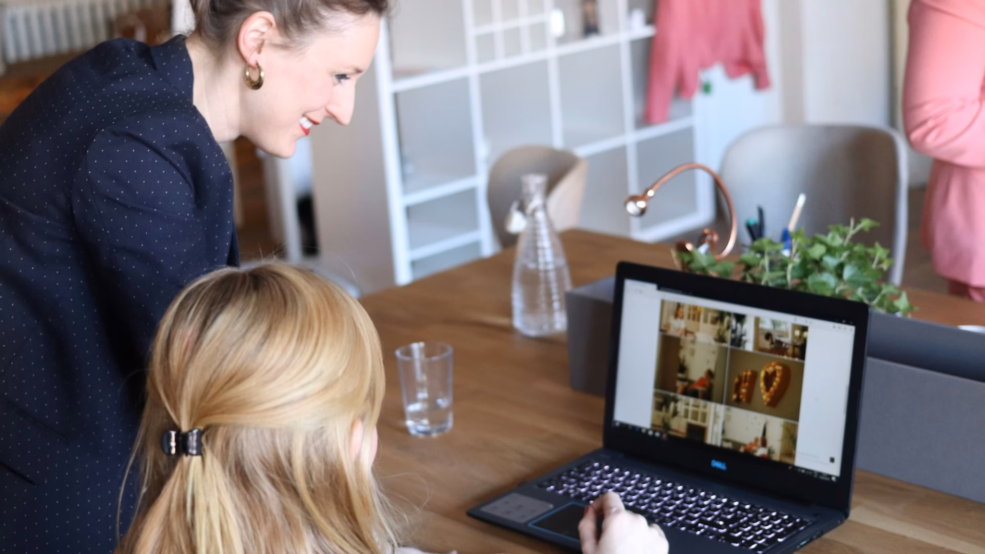 Two women at a desk pick out imagery for their real estate homepage