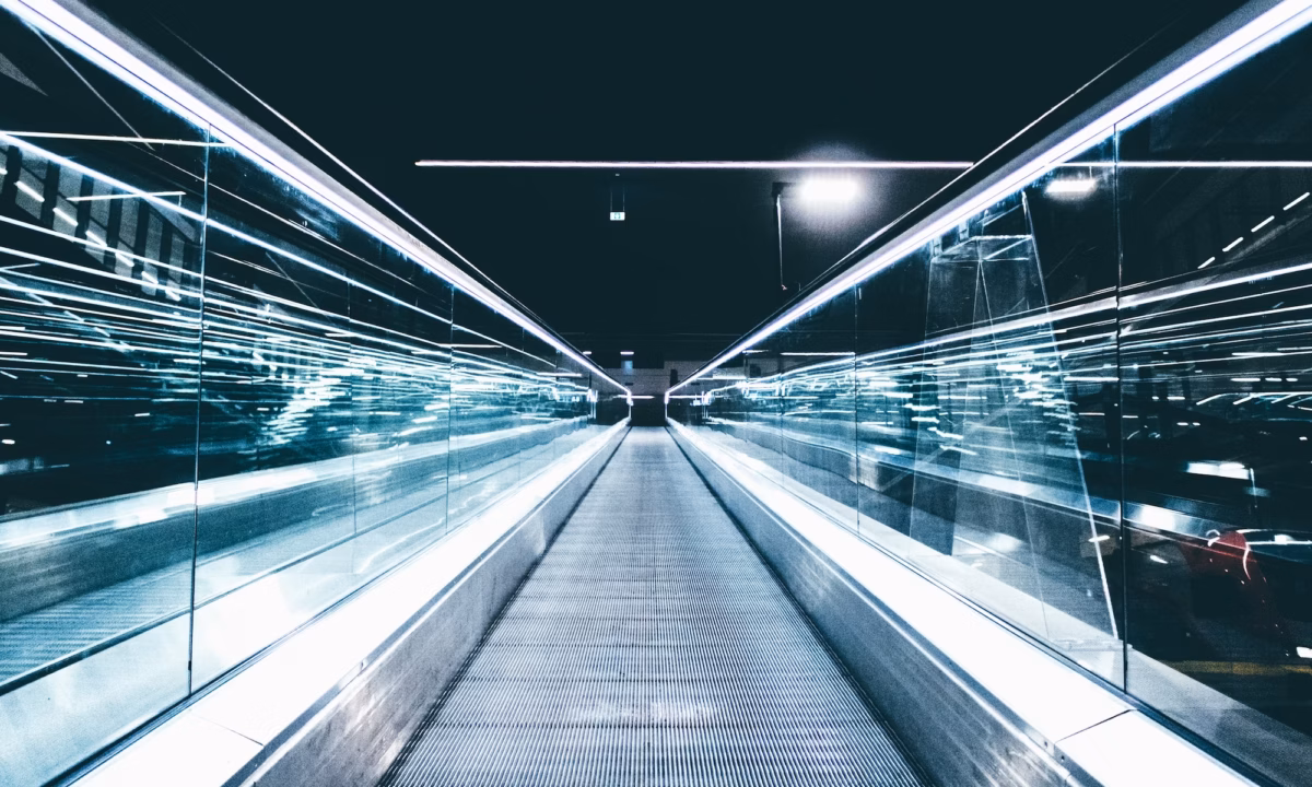 A moving walkway stretches ahead of the viewer, representing the future of the real estate industry during a time of change