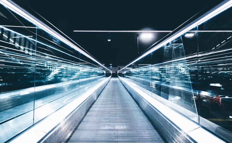 A moving walkway stretches ahead of the viewer, representing the future of the real estate industry during a time of change