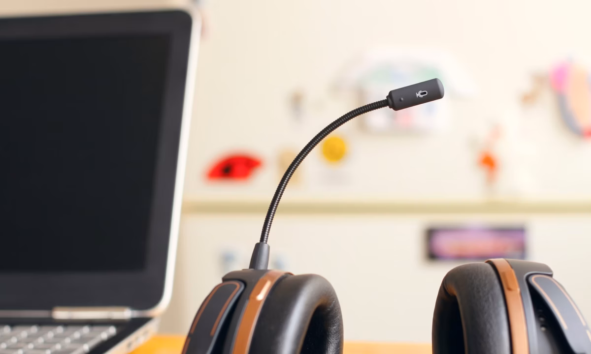 A headset with mic sits next to a laptop as a real estate professional ensures TCPA compliance in their lead generation strategies