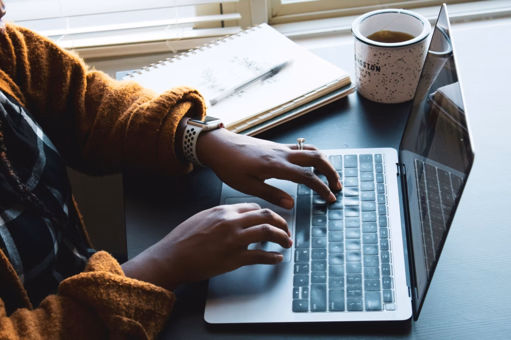 An agent sits in front of their laptop working on creating cost-effective real estate crm email campaigns