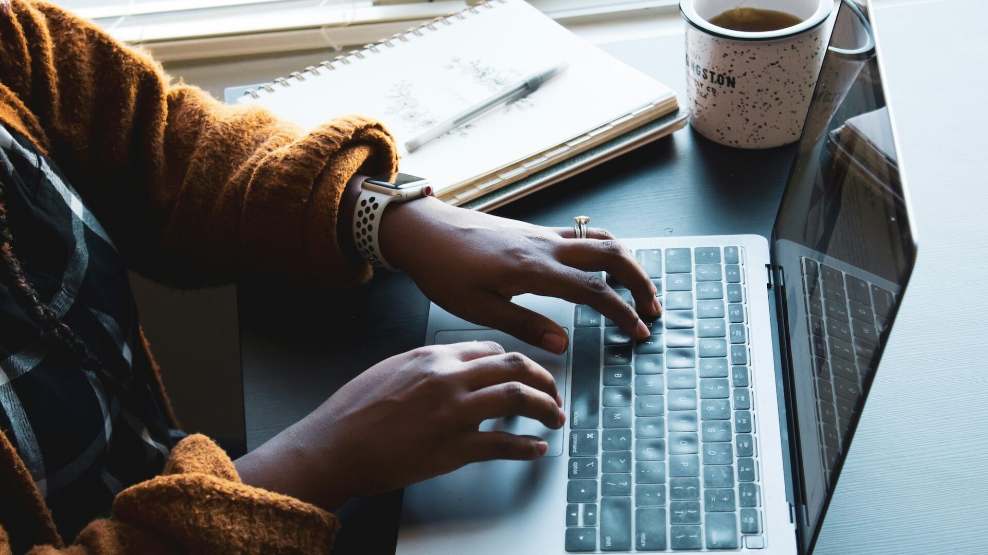 An agent sits in front of their laptop working on creating cost-effective real estate crm email campaigns