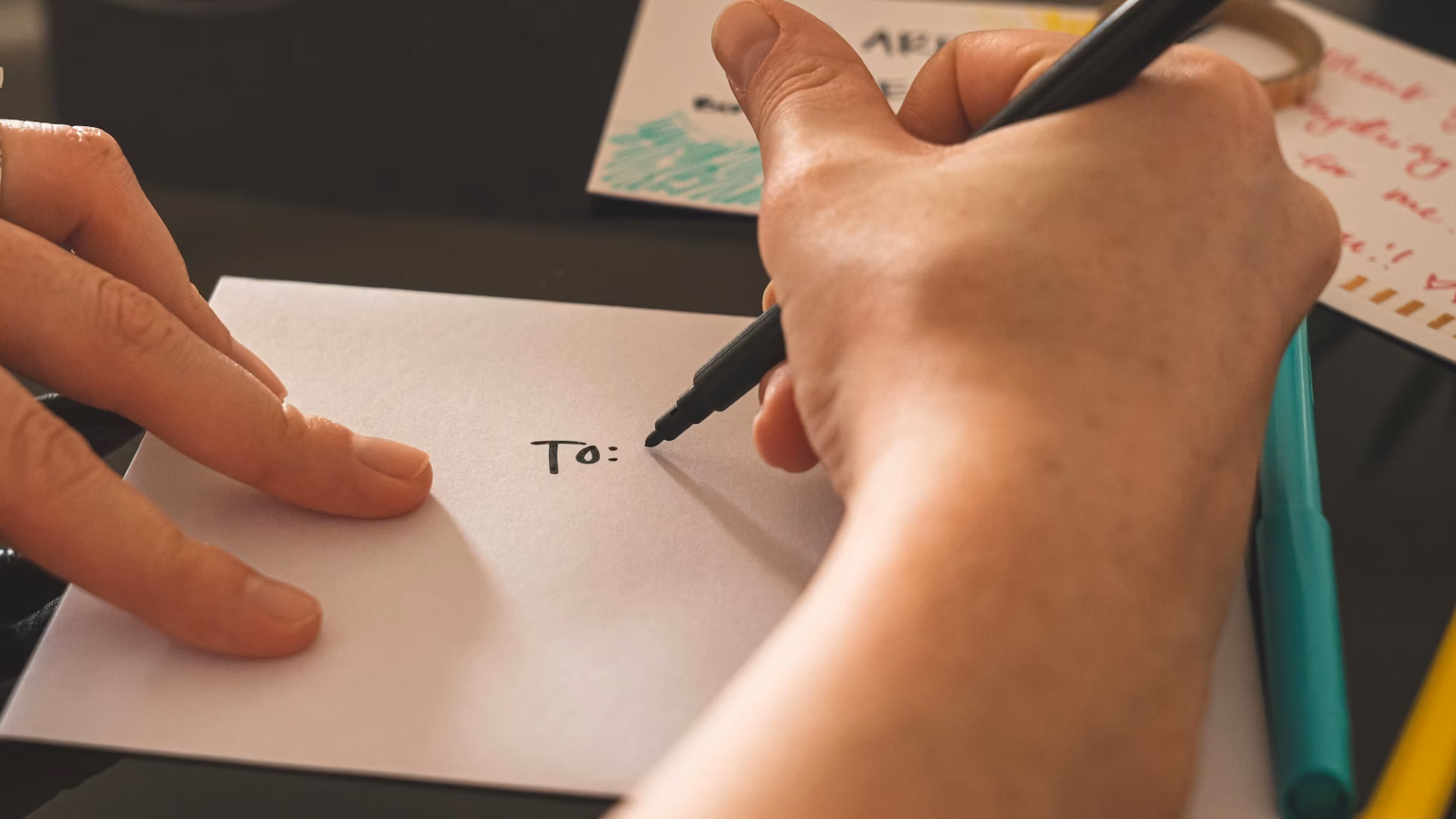 Real estate agent addressing an envelope to a prospect illustrating the need for personalization in marketing automation