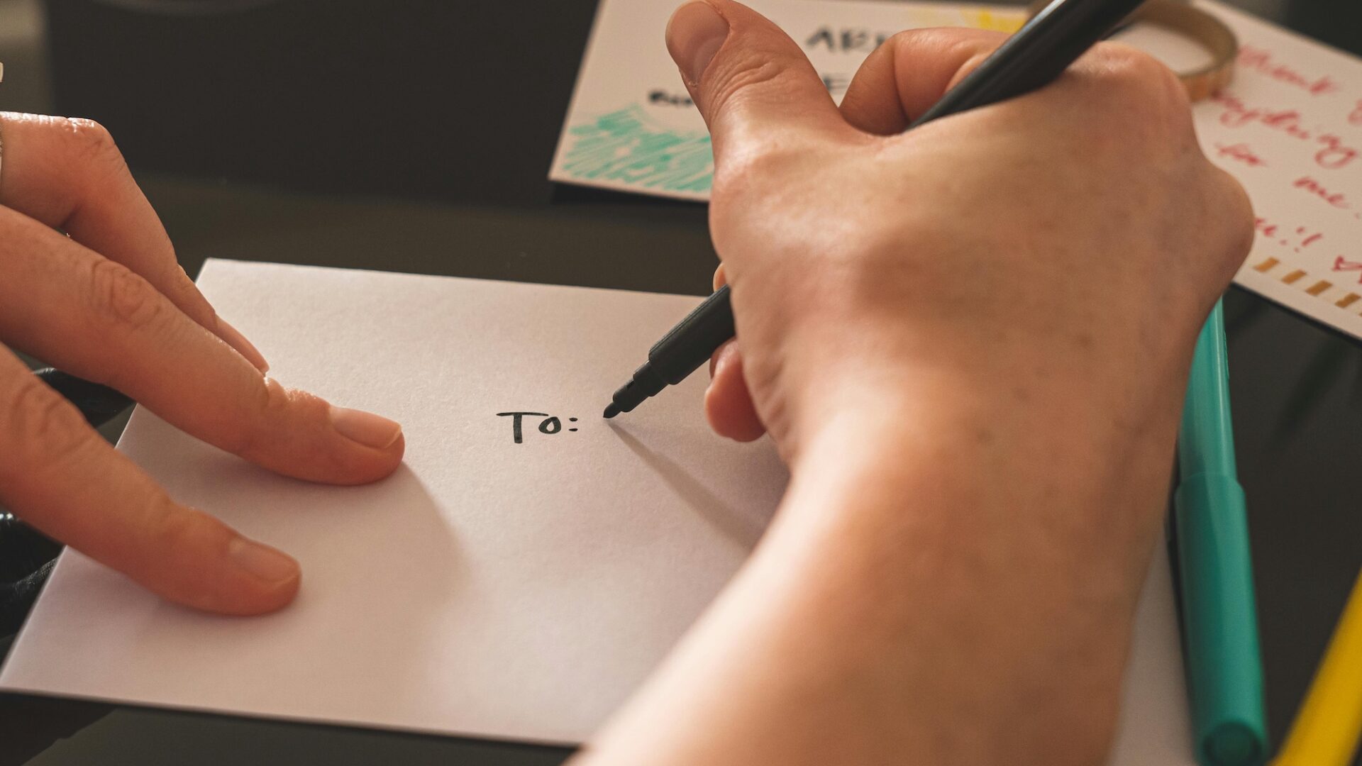 Real estate agent addressing an envelope to a prospect illustrating the need for personalization in marketing automation