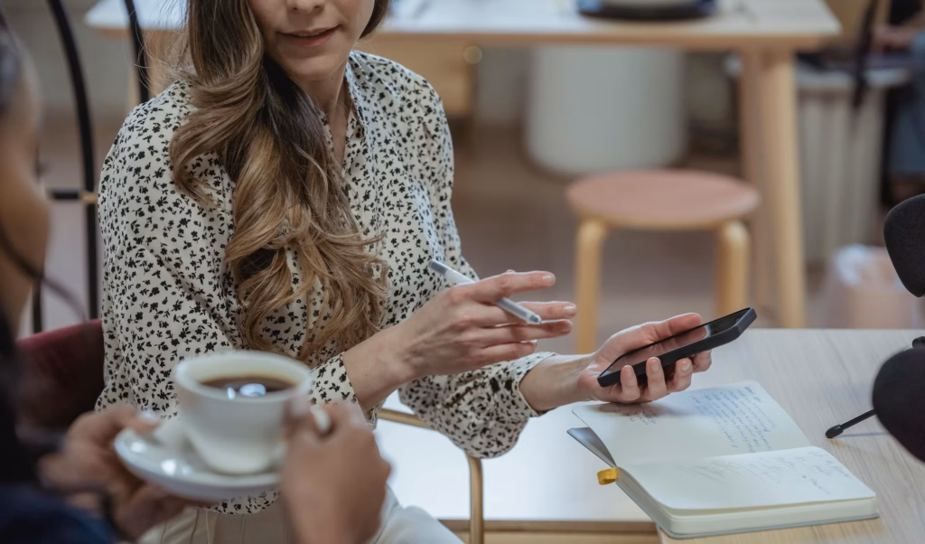 Two real estate agents in a brokerage talk about a property offered in a private listing network
