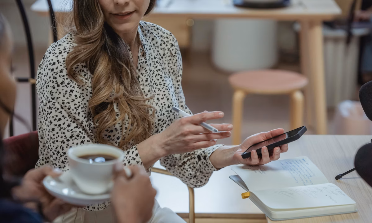 Two real estate agents in a brokerage talk about a property offered in a private listing network