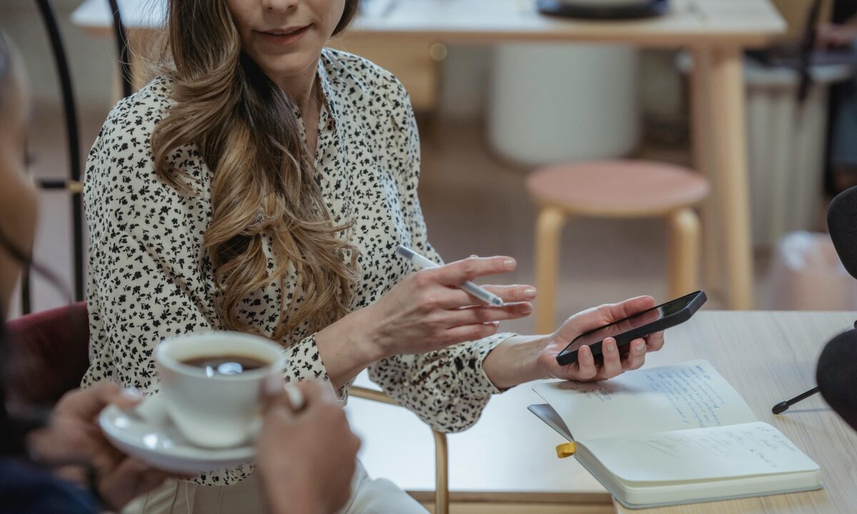 Two real estate agents in a brokerage talk about a property offered in a private listing network