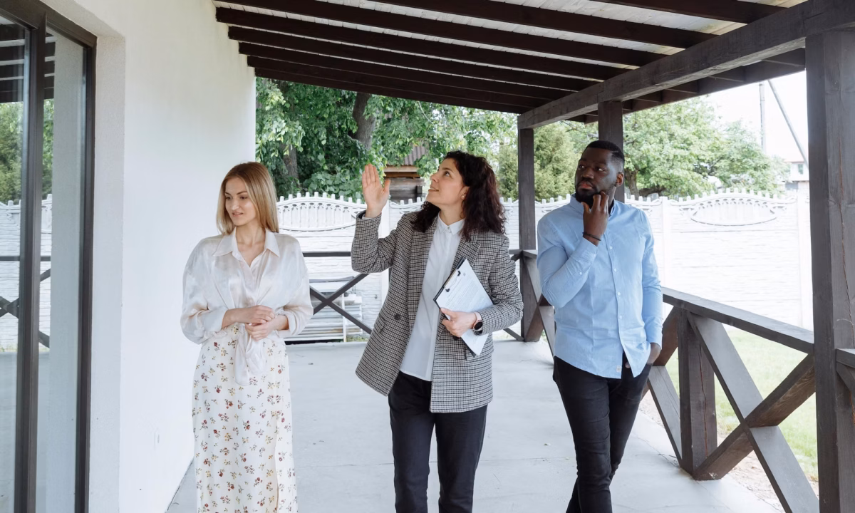 A real estate agent walks between two house hunters, using storytelling in marketing to help the buyers see how they fit into the narrative of the property