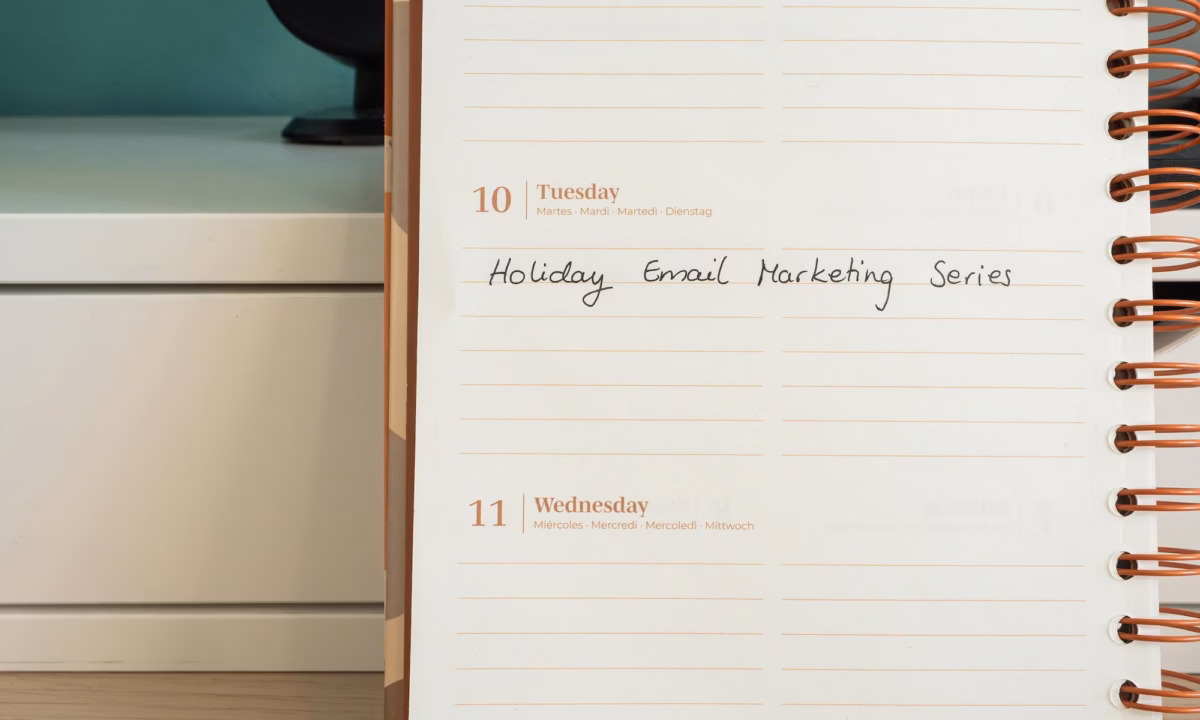 Close-up of a real estate professional's business planner notebook with a memo in it illustrating the best day and time to send email marketing