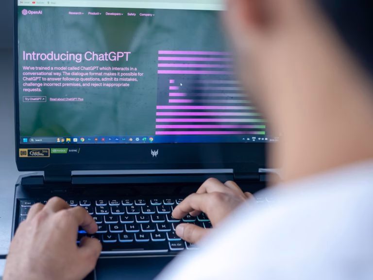 real estate agent sitting in front of a laptop using chatgpt prompts for email marketing