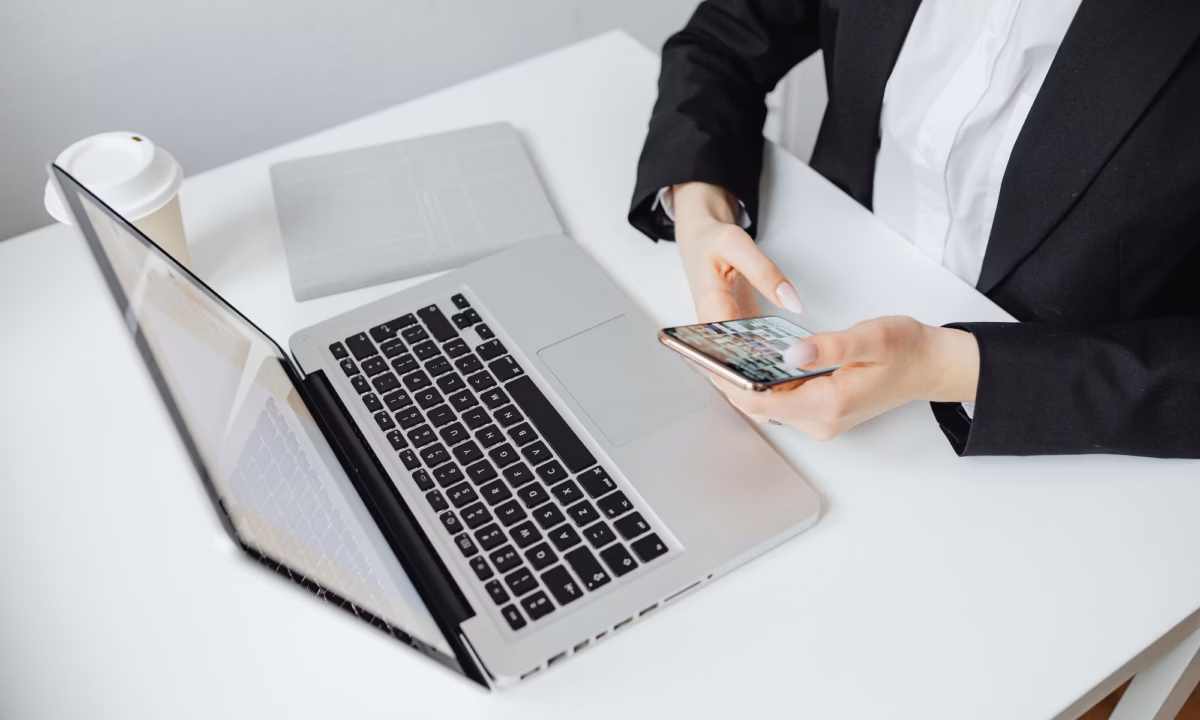 Real estate agent in front of laptop texting leads, leveraging email and SMS marketing strategies to move prospects down the sales funnel