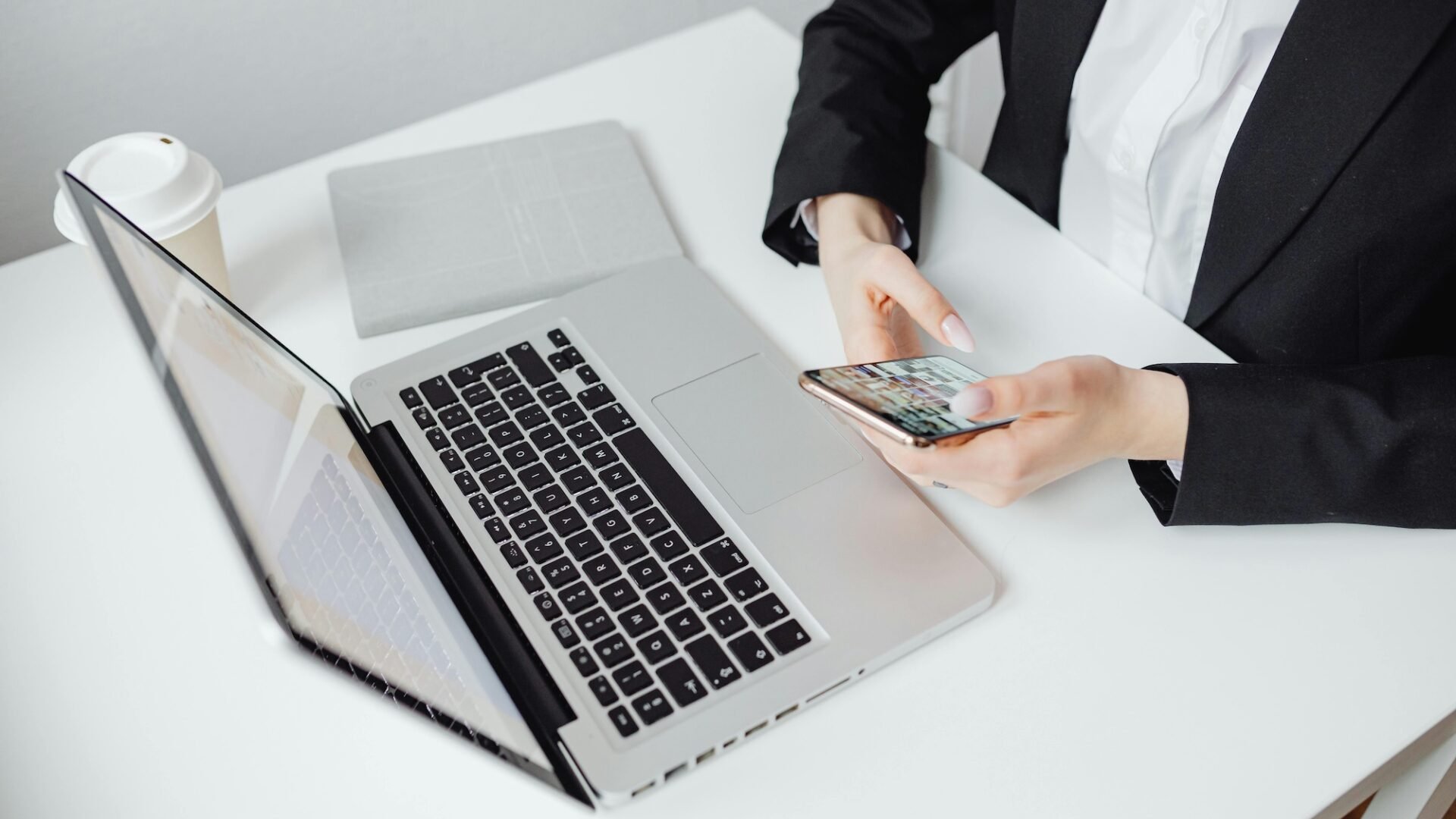 Real estate agent in front of laptop texting leads, leveraging email and SMS marketing strategies to move prospects down the sales funnel