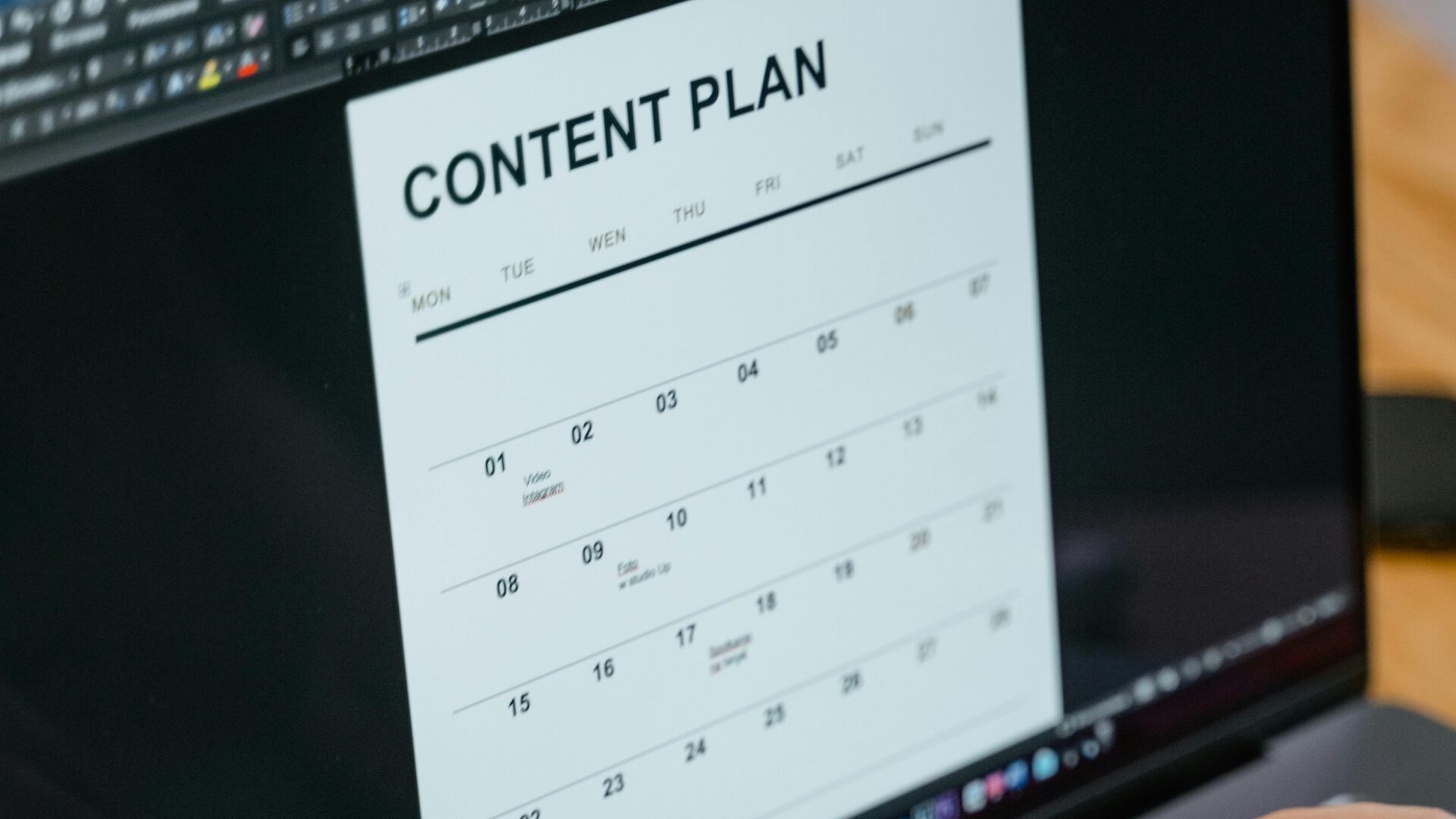 A real estate agent types of a laptop using email marketing tools such as a content calendar to promote her business