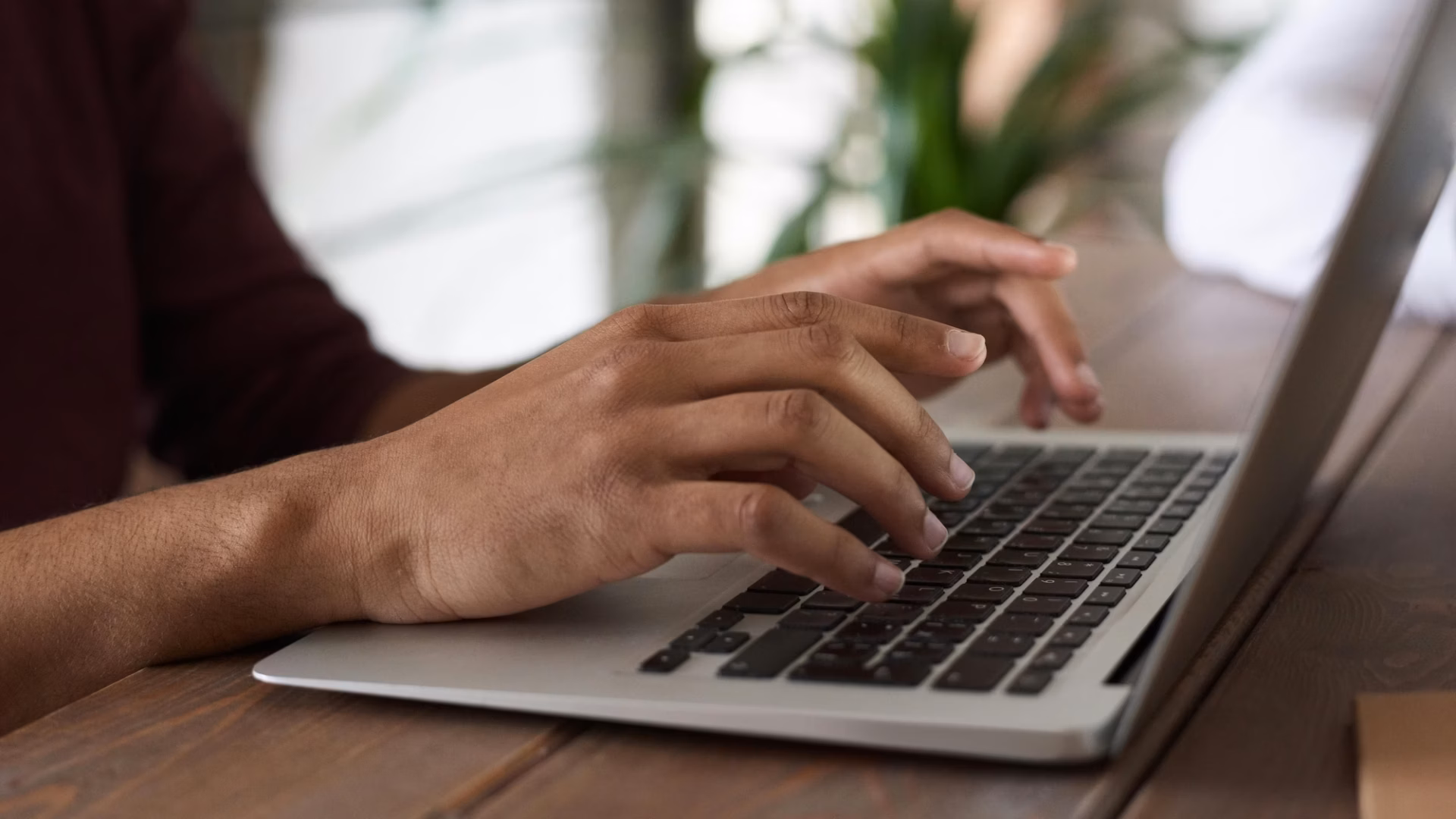 A real estate agent types out email marketing subject lines on their laptop for their latest outreach campaign to leads