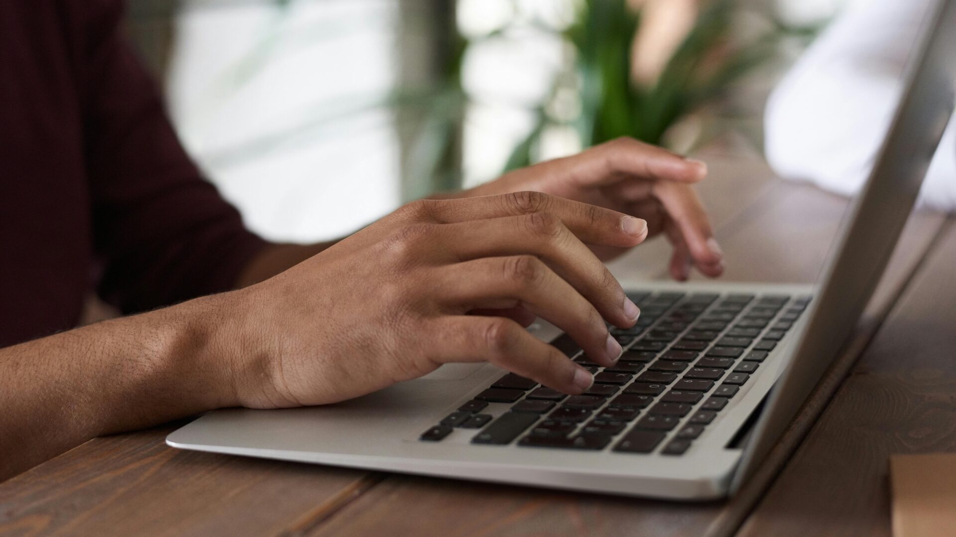 A real estate agent types out email marketing subject lines on their laptop for their latest outreach campaign to leads