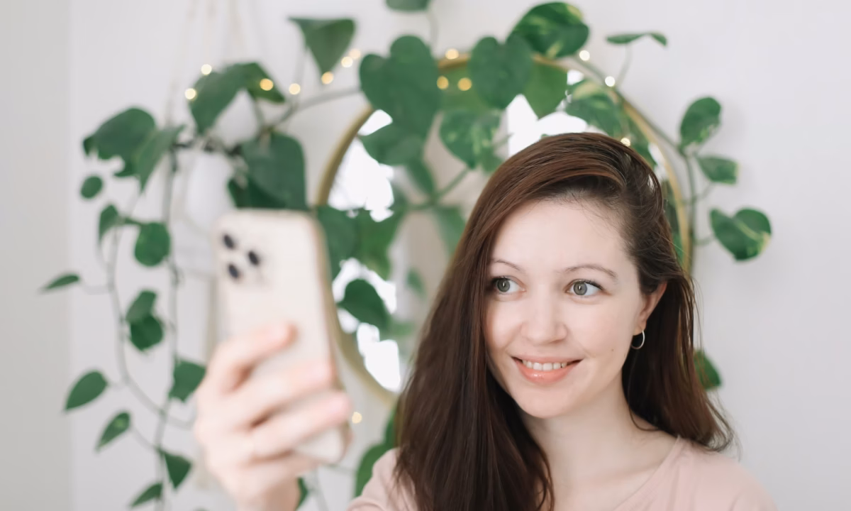 A real estate agent holds up her phone taking a selfie and demonstrating how to build a brand on instagram and linkedin