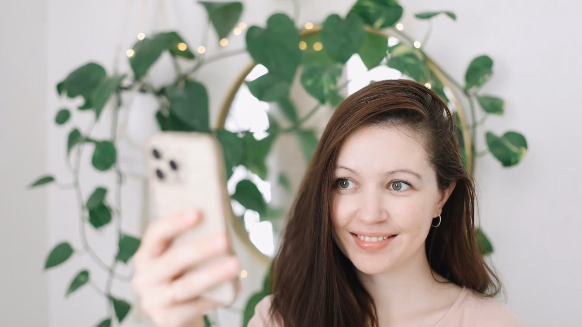 A real estate agent holds up her phone taking a selfie and demonstrating how to build a brand on instagram and linkedin