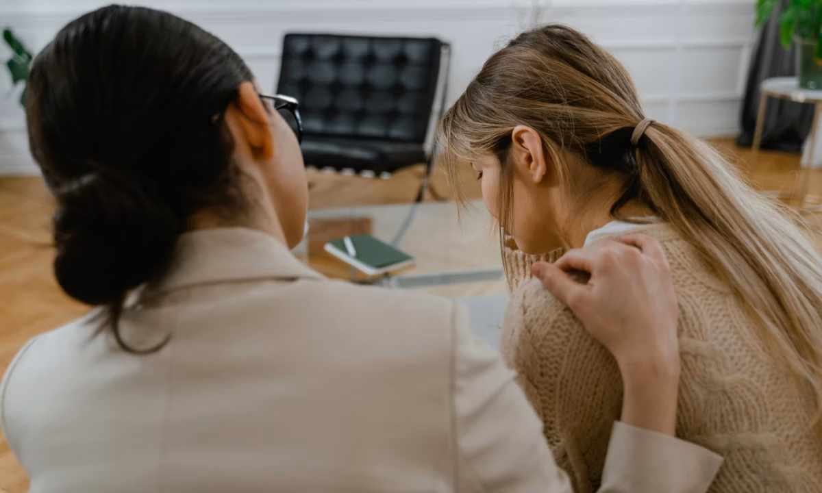Real estate agent comforts a woman who has lost her home in the 2025 LA wildfires