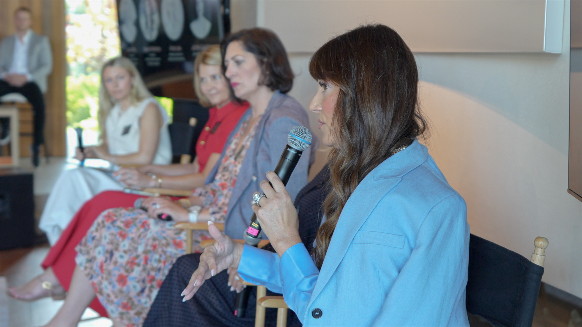 real estate team leader dawn mckenna speaks on a panel at a collective by luxury presence event in 2024