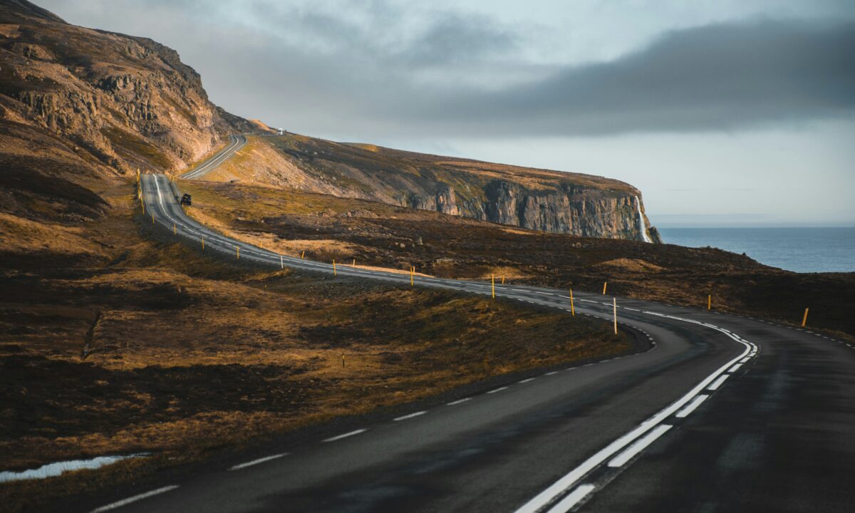 A winding road through a scenic landscape, symbolizing the real estate client journey