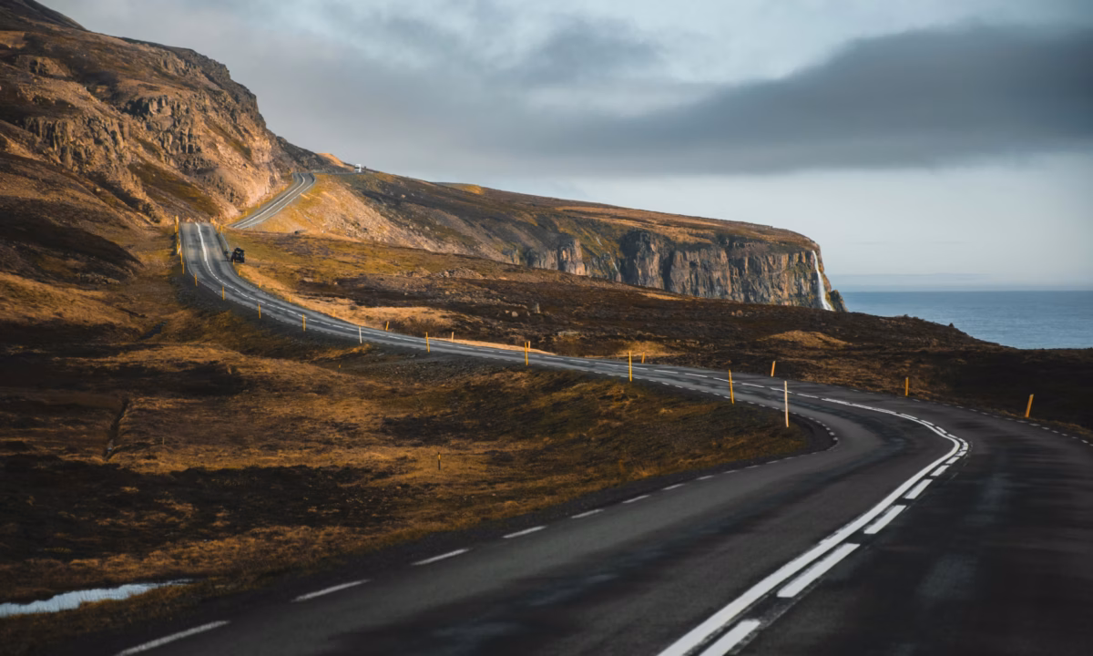 A winding road through a scenic landscape, symbolizing the real estate client journey