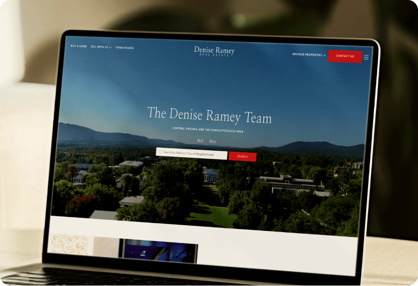 A laptop showing the home page of the Denise Ramey real estate team's website