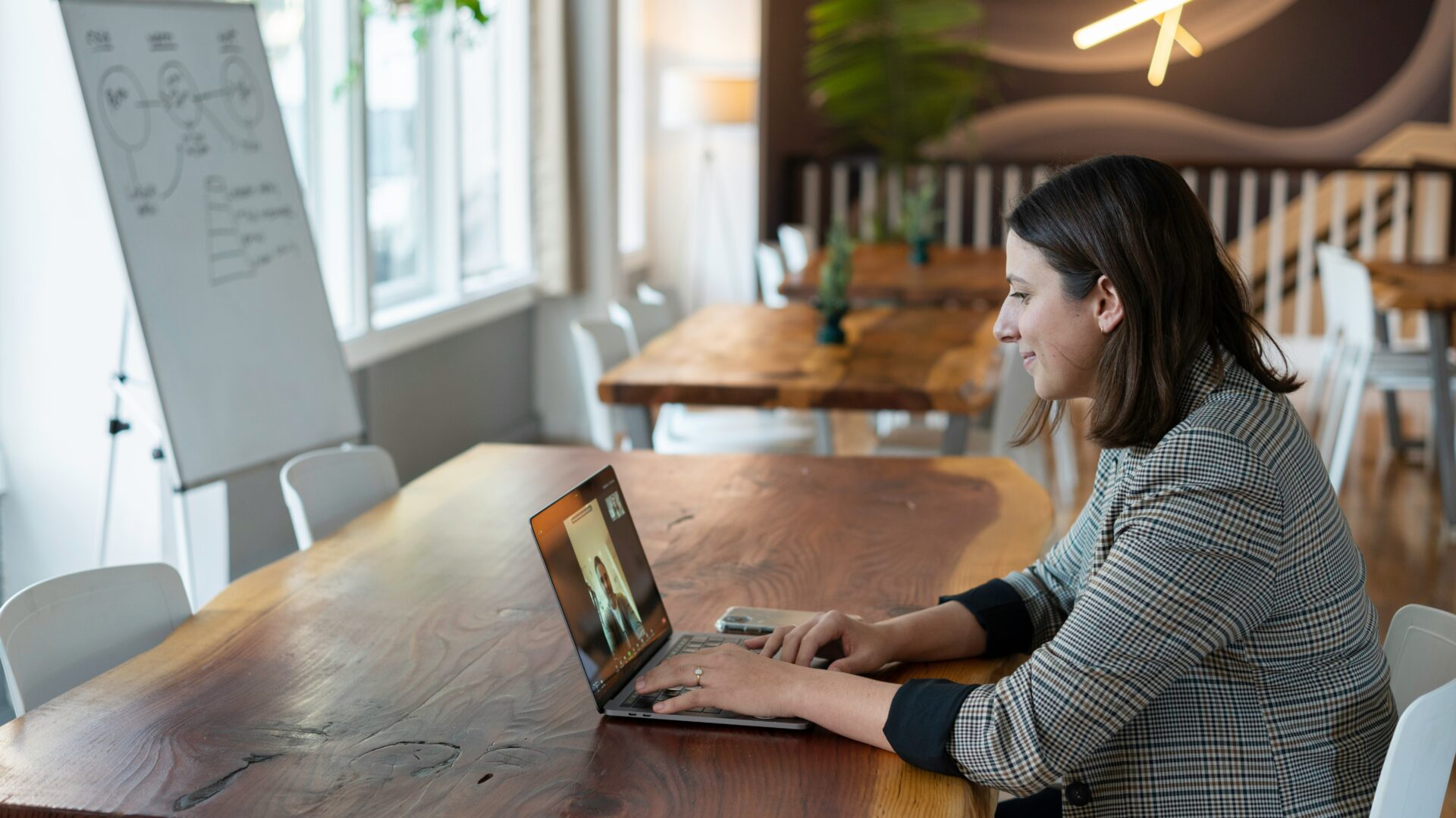 real estate agent works on her computer with the benefit of an AI social media assistant