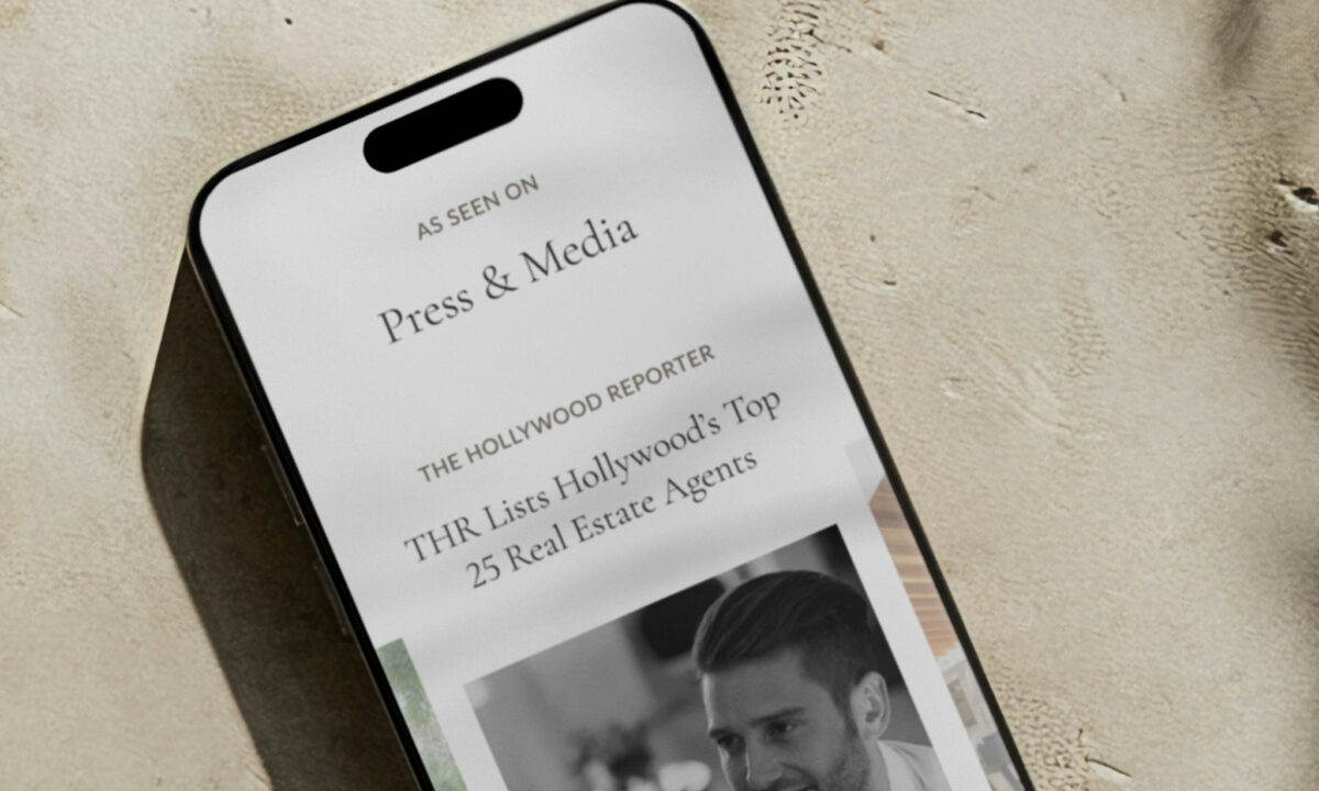 A smartphone with a press release for a real estate website on the screen